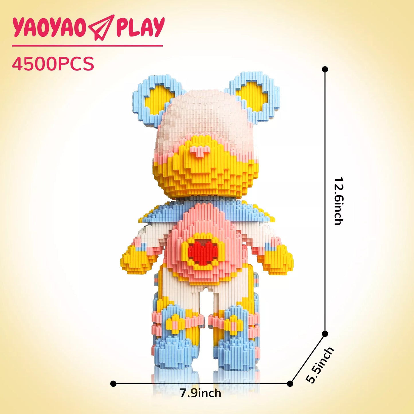 A Brick Bear toy with light pink head, blue/yellow ears, red heart torso, and labeled dimensions (12.6" height) on a neutral backdrop