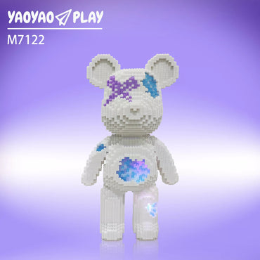 A white Brick Bear toy with purple-blue accents labeled "M7122" against a gradient backdrop.