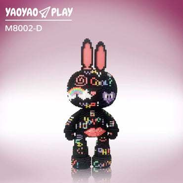 A black Brick Bear toy with neon heart, cloud, and text motifs on a lavender-to-pink gradient backdrop.