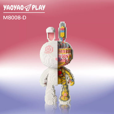 A split-design Brick Bear toy with minimalist white and anatomical multicolored details on a gradient backdrop.