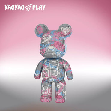 A Brick Bear toy with rounded ears, heart accents, and pink/blue mosaic patterns on a pink-to-gray gradient.