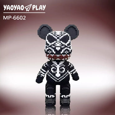 A black-and-white Brick Bear toy (Model MP-6602) with red-accented mouth and geometric patterns on a burgundy gradient.