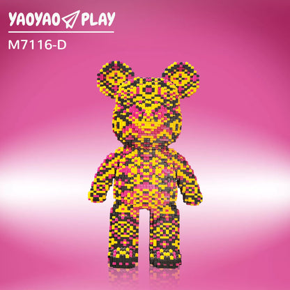 A Kumamon-inspired ​​Brick Bear toy​​ with yellow, pink, and black pixel blocks, model "M7116-D," on a gradient pink backdrop